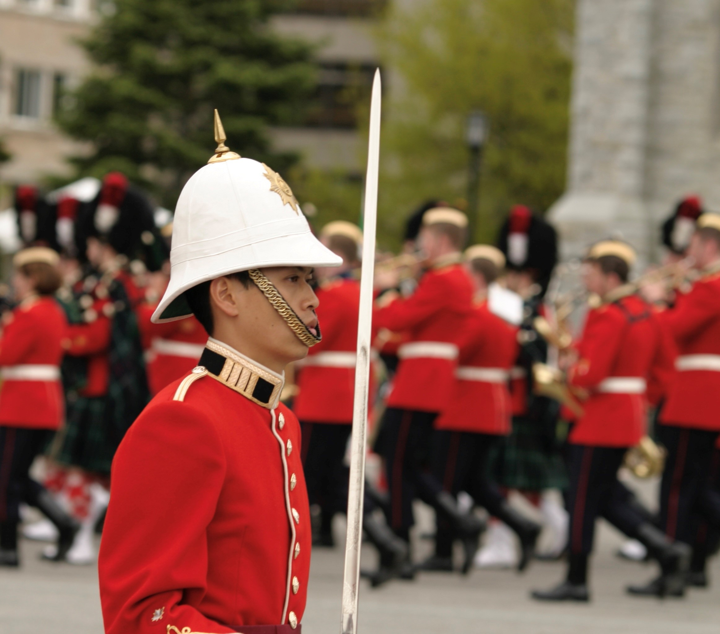 A soldier in uniform is marching in a military parade uniform.