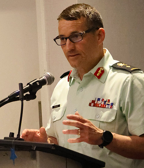 BGen Serge Ménard stands in the podium and gives his remarks.