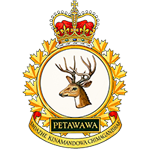 A Canadian Army insignia with a crown above a circular emblem featuring a deer head. A banner below reads “Petawawa,” with additional text in an Indigenous language forming a motto.