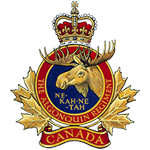 Canadian Army badge showing a gold maple leaf with a blue circular centre. Inside the circle is a gold elk head with the motto “NE KA NE TAH” below. Around the circle appears the text “THE ROYAL CANADIAN REGIMENT.” A red and gold crown sits at the top, and a red banner at the bottom reads “CANADA.”