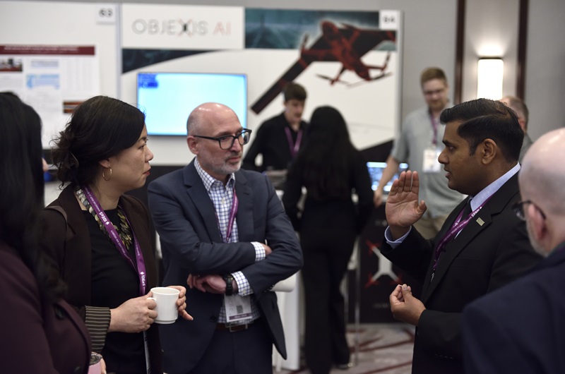 Participants view and discuss defence innovation displays at the IDEaS Marketplace event in Ottawa.