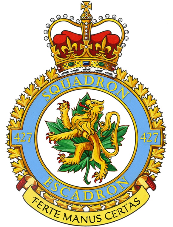 The badge of the 427 Special Operations Aviation Squadron, which is a golden lion on top of a green maple leaf, within a blue circle with the inscriptions 427 Squadron Escadron 427, and under the circle in a yellow scroll, the inscription Ferte Manus Certas. A crown is on top of the circle.