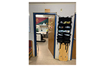 The entrance to a temporary Arctic medical facility displays emergency medical equipment, a patient evacuation stretcher, and a medical treatment room.