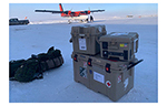 Medical equipment containers and rucksacks sit on a snow-covered airstrip beside a twin-engine aircraft after arrival in the High Arctic in support of NOREX 2026.