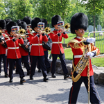 Members of the Ceremonial Guard Band march along a pathway in the National Military Cemetery during the 25th anniversary commemorative ceremony.