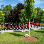 Members of the Ceremonial Guard march along a pathway at the National Military Cemetery during the 25th anniversary commemorative ceremony.