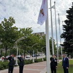 The Canadian Armed Forces Flag is raised at Ottawa City Hall as military members and a civic representative look on during a ceremony marking the 25th anniversary of the National Military Cemetery.