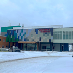 Exterior view of Whitehorse General Hospital during winter, with snow-covered grounds surrounding the emergency department entrance.