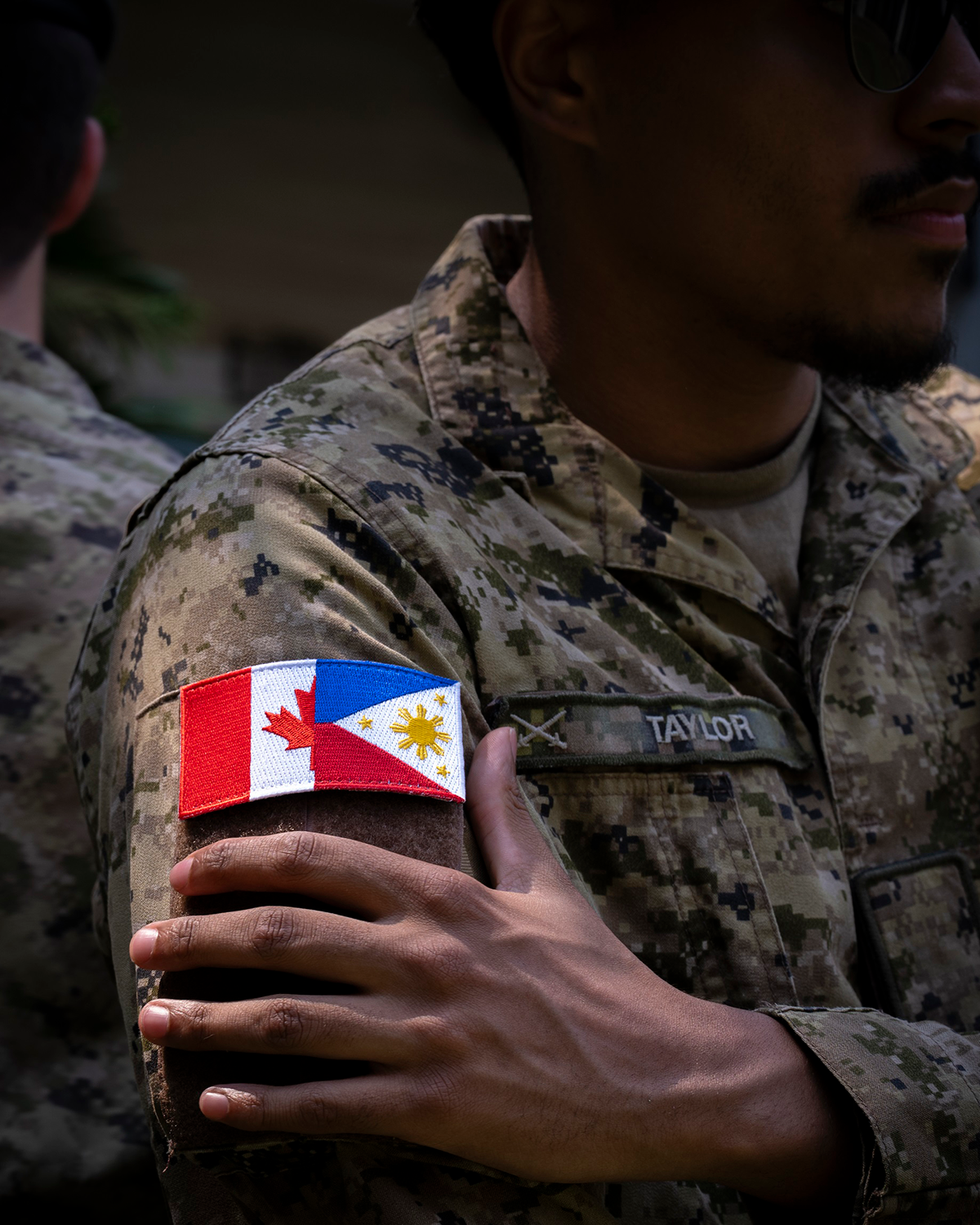 Close-up of a service member during Exercise Balikatan 2026 wearing a shoulder patch featuring the Canadian and Philippine flags, symbolizing growing defence cooperation between Canada and the Philippines.
