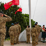 1 Cdn Div HQ Commanding Officer Lieutenant-Colonel Vintar salutes as the 1 Cdn Div flag is lowered for the last time at the sunset ceremony.