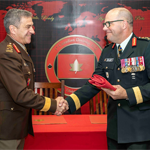 Commander CJOC, LGen. J.M.S. Boivin and Commander Canadian Army, LGen. M.C. Wright shake hands and exchange the 1 Cdn Div flag.
