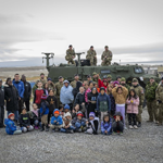 Several military vehicles such as a Tactical Armoured Patrol Vehicle (TAPV), a Fat Truck, and a Bandvagn 206 (BV 206), make their way toward the community of Resolute Bay, Nunavut, for a visit with the community on August 25. Photo by: Master Corporal Natasha Punt