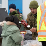 Corporal Raymond serves a hot dog to a student from Qarmartalik School in Resolute Bay, Nunavut, after the Terry Fox run. Canadian Armed Forces personnel ran alongside students and staff of Qarmartalik School during a local Terry Fox Run event on September 4, supporting community outreach while deployed on Operation NANOOK-NUNAKPUT. Photo: Corporal Nicholas Zahari