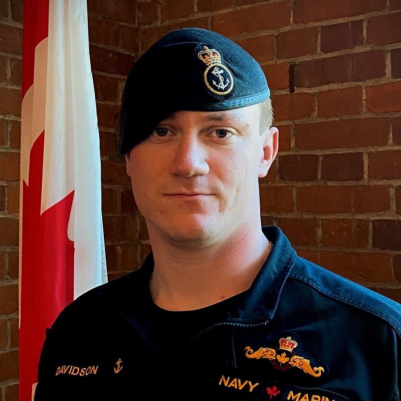 This photo shows S1 Davidson in front of the Canadian flag.