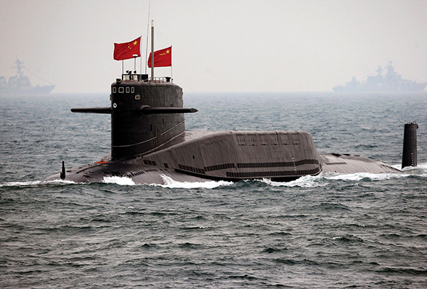 A submarine displaying the Chinese flag comes to the surface of the water.