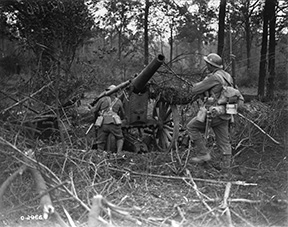 Machine gunners advancing into a wood passing.