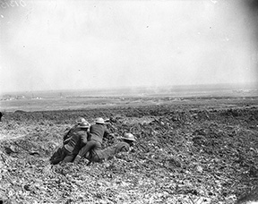 This photograph depicts five Canadian observers huddled in a fox hole overlooking the Battle of Arleux. The Battle of Arleux (April 28-29, 1917) was part of the Battle of Arras.