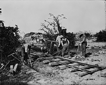 Canadian Railway Troops laying track in shelled area. September, 1917.