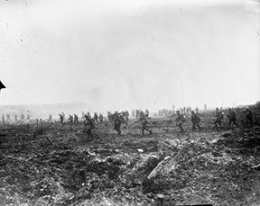 29th Infantry Battalion advancing over “No Man's Land” through the German barbed wire.