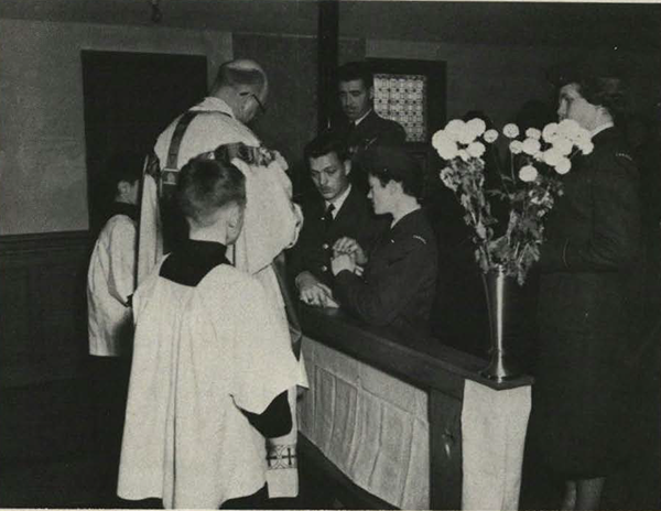 A priest marrying a couple in a church.