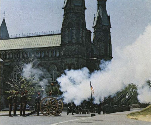 Soldiers firing canons in front of the Parliament buildings.