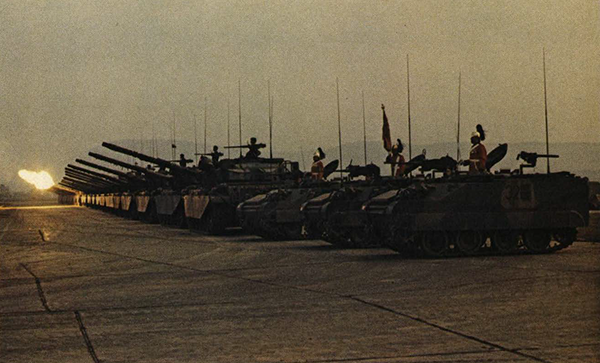 A row of tanks in a field.