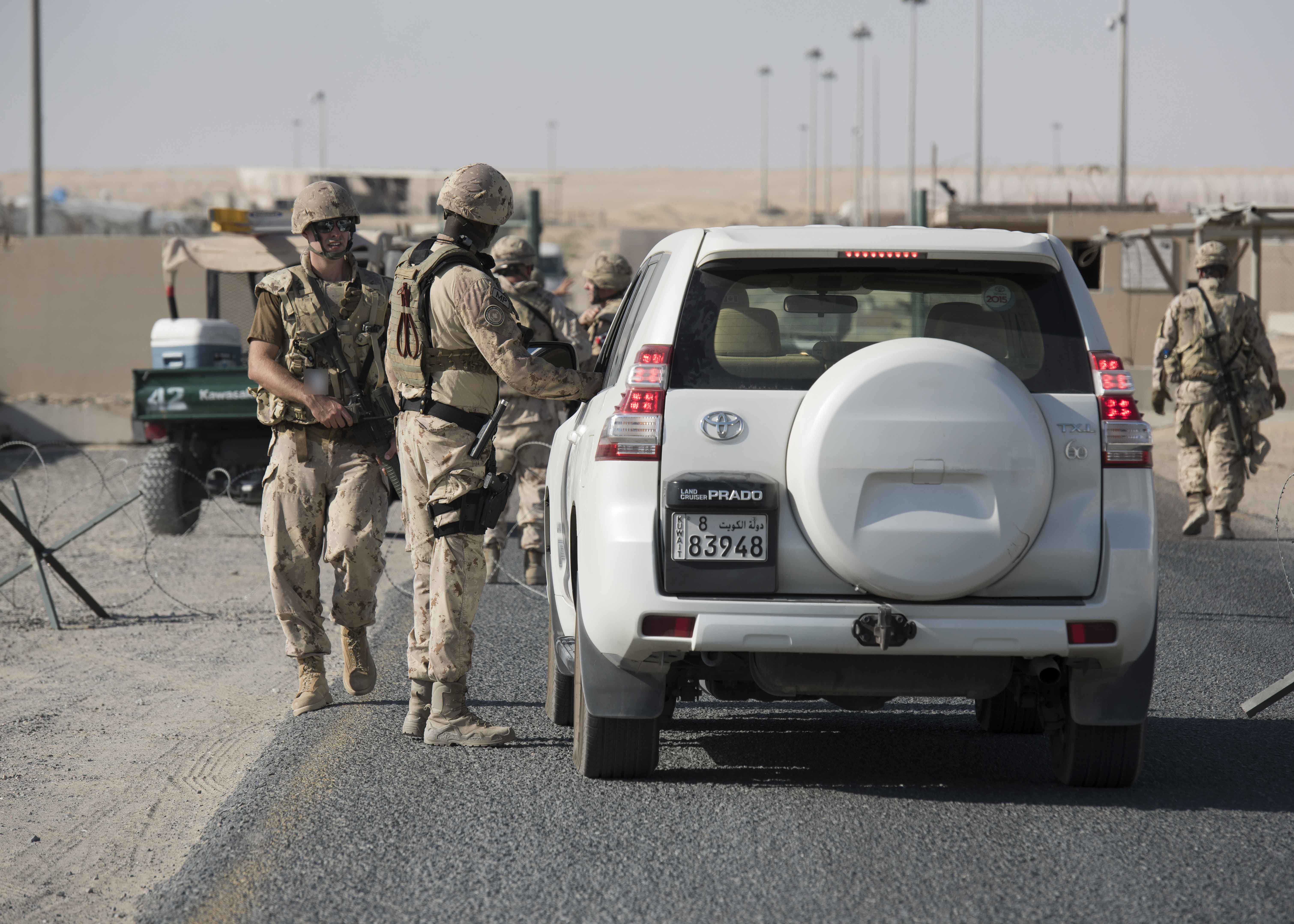 A Canadian Armed Forces Military Police member checks identification at a vehicle checkpoint during an active shooter lockdown scenario exercise conducted at Camp Canada, Kuwait, 29 September 2018. Image by:  Op IMPACT Imaging