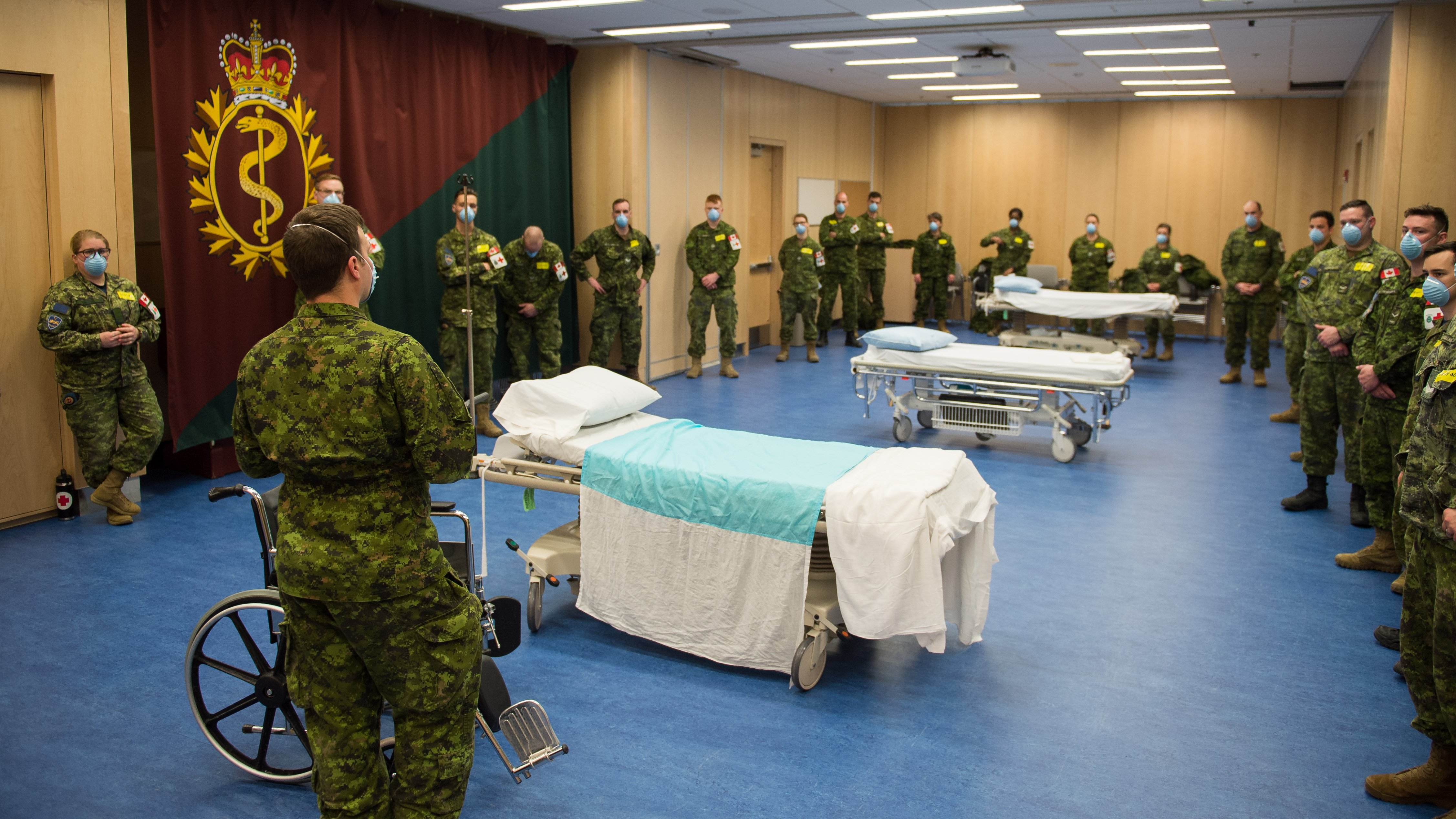 A member of the 4 Health Services Group (4 H Svcs Gp), performs a triage in order to enter the Saint-Jean garrison clinic for training during Operation LASER.