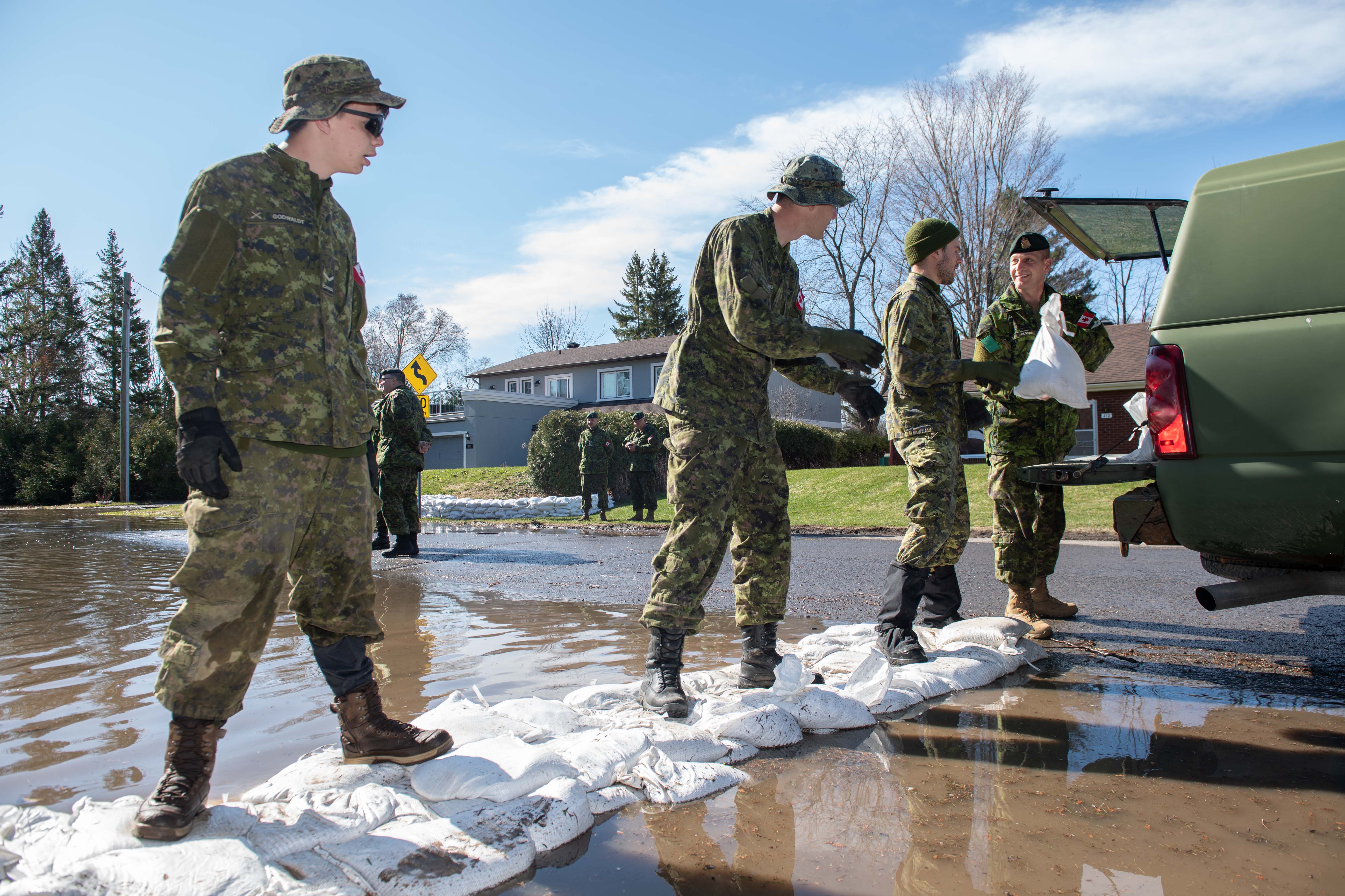 Chief Warrant Officer (CWO) Olstad, 4th Canadian Division Sergeant-Major and members of 4th Canadian Division unload sandbags used to assist Constance Bay residents in barricading water during Operation LENTUS on April 29, 2019. Photo: Master Corporal Donnie McDonald, 4 Canadian Division Headquarters Public Affairs