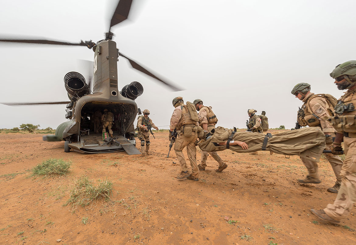 Soldiers practice a medical evacuation and board an aircraft.