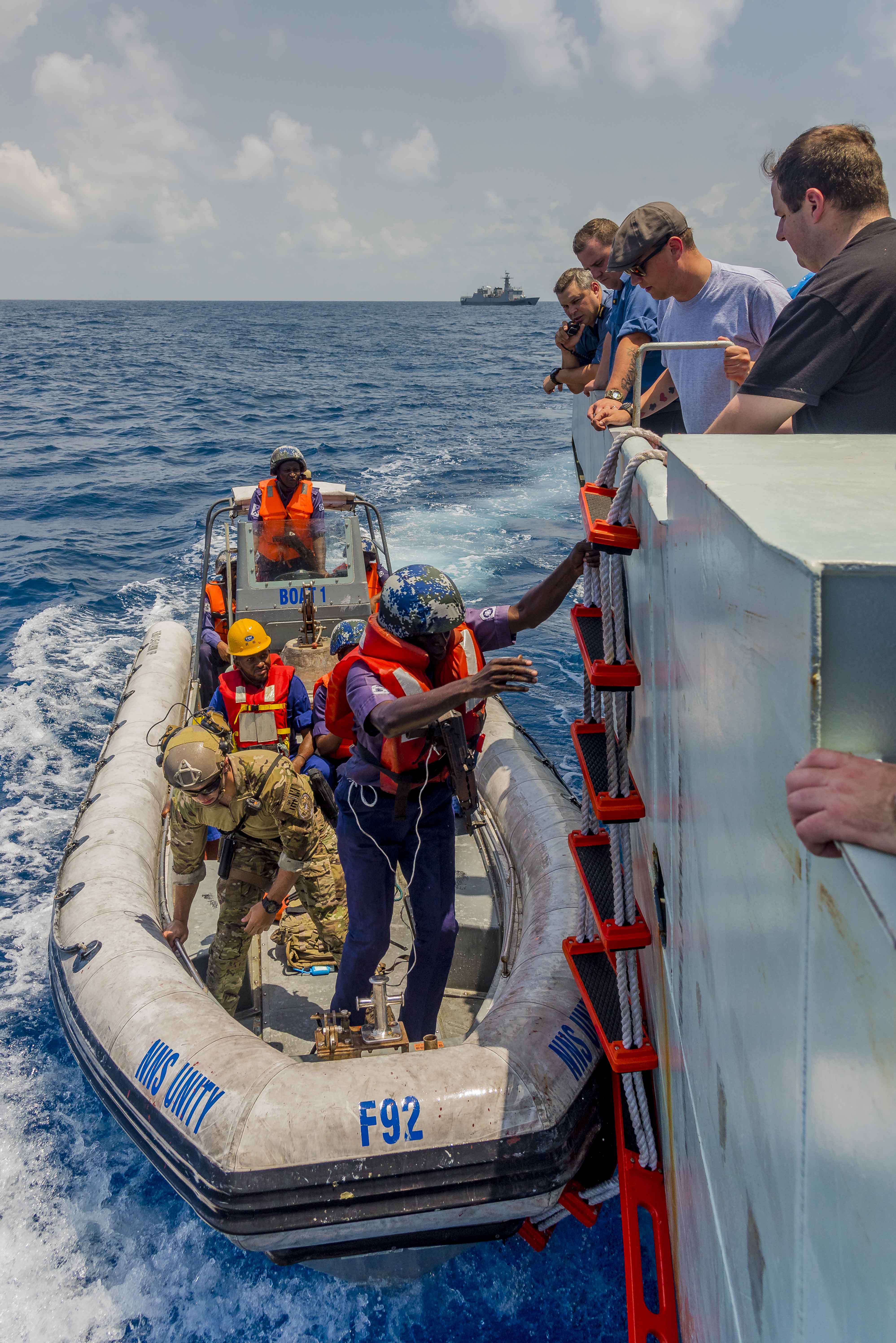 March 12, 2018. Members of the Nigerian Navy and United States Coast Guard (USCG) board Her Majesty's Canadian Ship (HMCS) KINGSTON from a rigid hulled inflatable boat (RHIB) as part of a training exercise during Operation PROJECTION west Africa off the coast of the port city of Lagos, Nigeria, March 12, 2018. Photo: Ordinary Seaman (OS) John Iglesias Formation Imaging Services