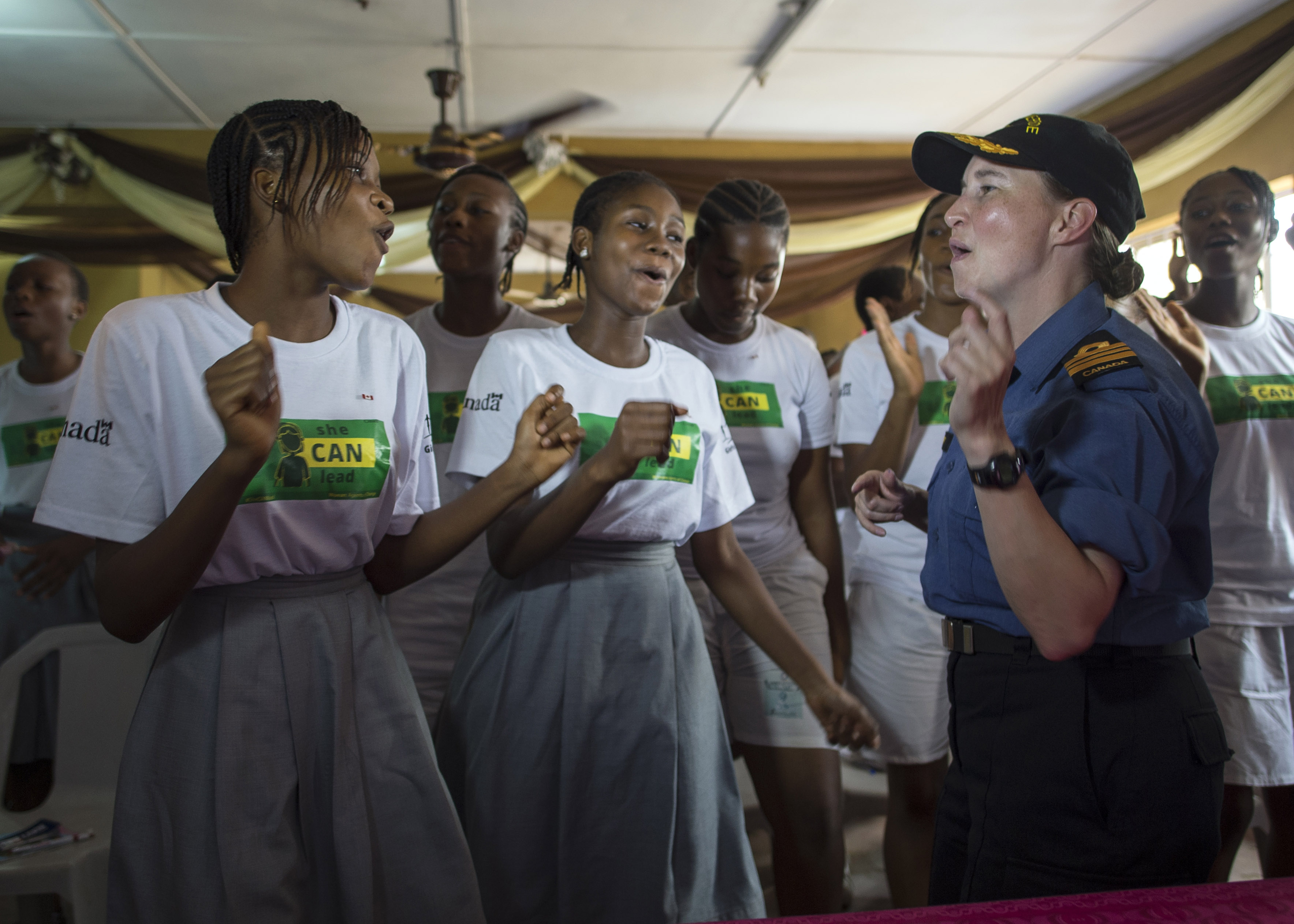 March 12, 2018. Lieutenant Commander Emily Lambert, Commanding Officer of Her Majesty’s Canadian Ship (HMCS) SUMMERSIDE, sings and dances with the students from Gwat Private College during Operation PROJECTION, March 12, 2018. Photo: Sgt Shilo Adamson, Canadian Forces Recruiting Group Headquarters, CFB Borden