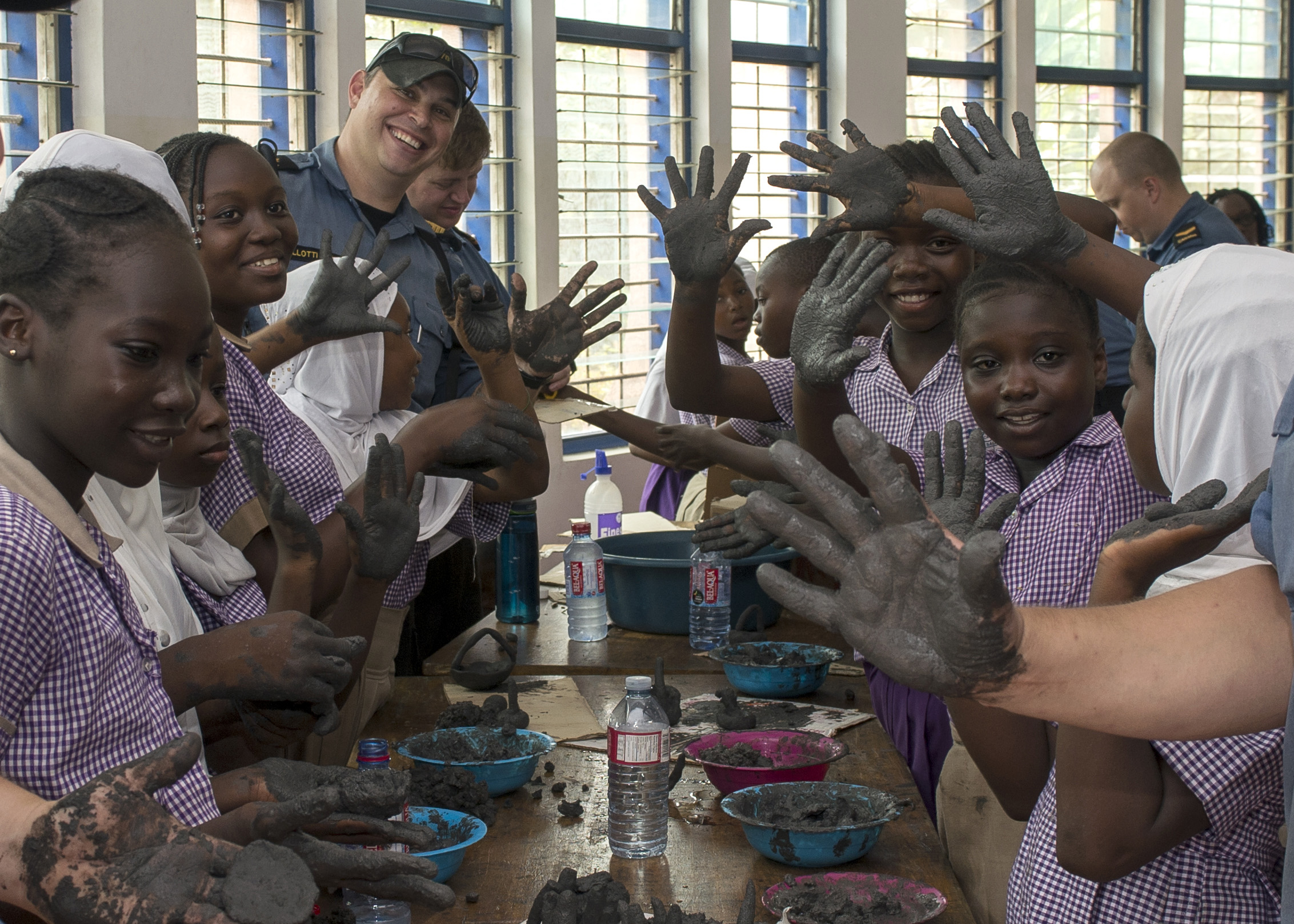 March 21, 2018. Leading Seaman Peter Sayeau (left) and Leading Seaman Edward Kuipers, Members of Her Majesty’s Canadian Ship KINGSTON, do arts and crafts with students at the Nima-Maamobi community Learning center in Accra, Ghana, during Operation PROJECTION, March 21, 2018. Photo: Sgt Shilo Adamson, Canadian Forces Recruiting Group Headquarters, CFB Borden