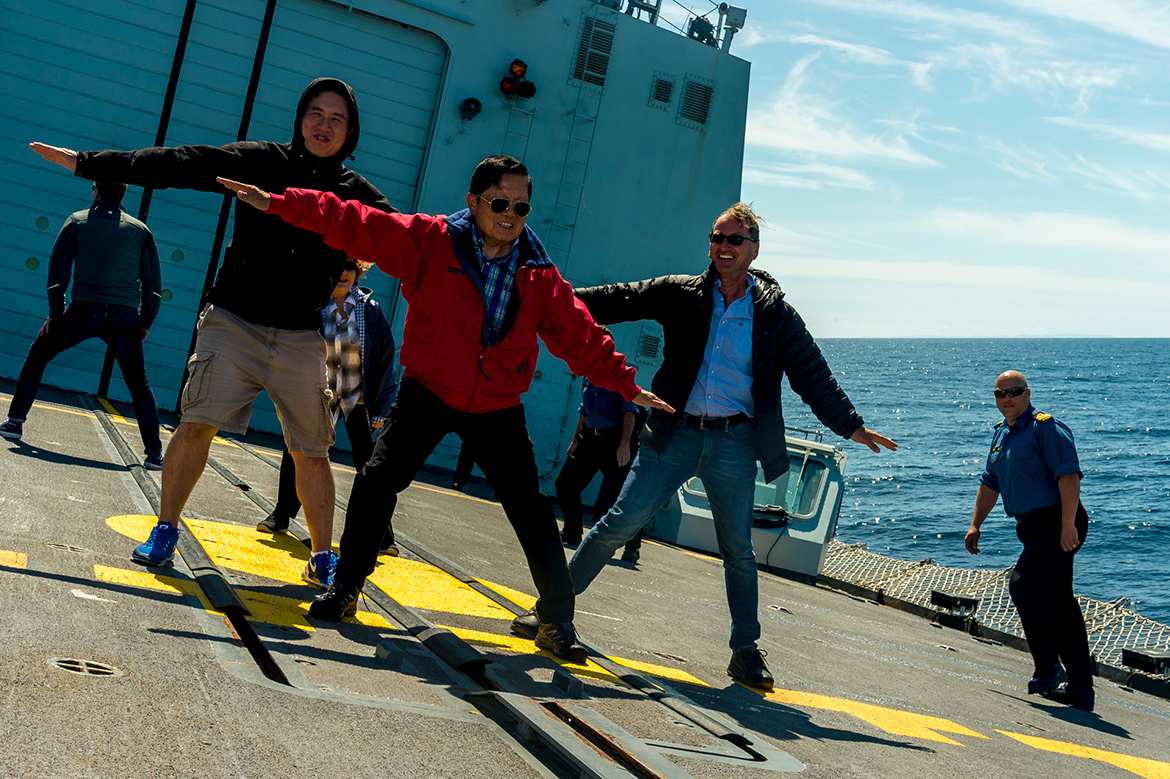 “Participants of the Canadian Armed Forces Parliamentary Program | Royal Canadian Navy (RCN) Arctic Canadian Leaders at Sea (CLaS) Program aboard HMCS Charlottetown from St. John’s NL to Iqaluit, NU (12-16 Aug 2018), standing on the flight deck of HMCS Charlottetown conducting High Speed Manoeuvring demonstration off the eastern coast of Newfoundland & Labrador (12th Aug 2018). <br> Left to Right: Shaun Chen, MP, Scarborough North, ON, Irene Mathyssen (behind in purple jacket), MP, London - Fanshawe, ON, Victor Oh, Senator, Mississauga, ON, Richard Hébert, MP, Lac-Saint-Jean, QC and Lieutenant-Commander Adriano Lozer, Executive Officer, HMCS Charlottetown (far right).