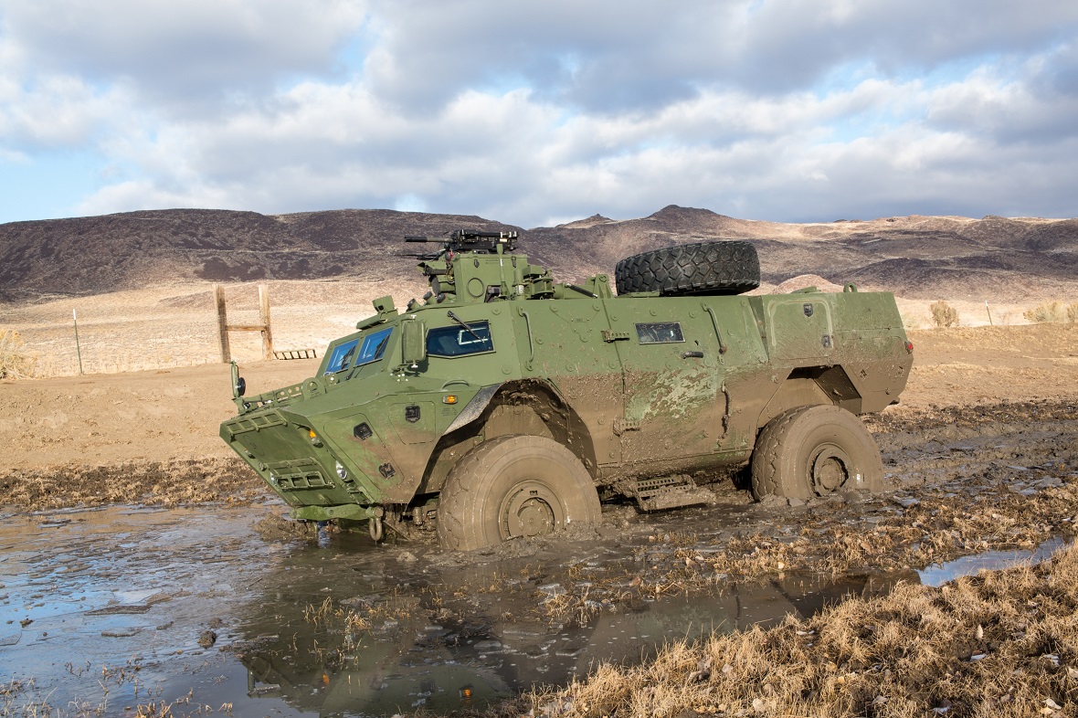 Vue de côté de blindé tactique de patrouille de véhicules en terrain boueux. Photo fournie par le : Textron Systems Canada Inc.