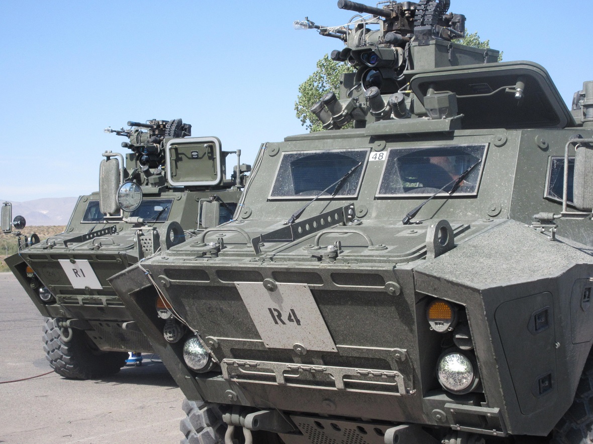 Vue de face de blindé tactique de patrouille de véhicules en terrain boueux. Photo fournie par le : Textron Systems Canada Inc.