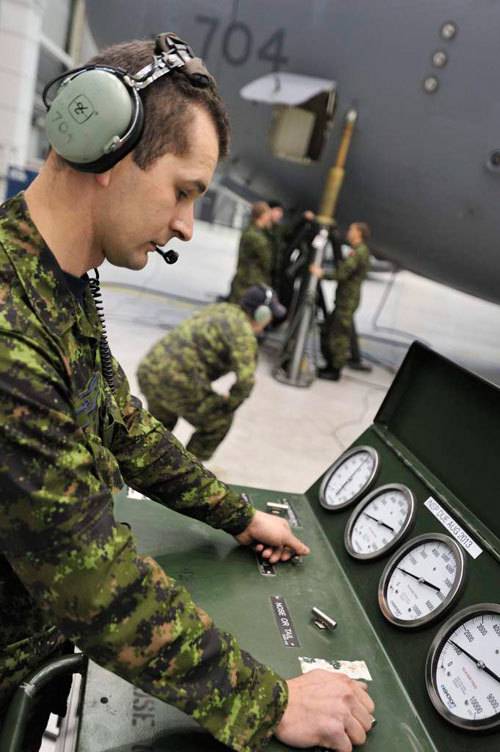 Master Corporal Mieszco Jachira-Cmolassowski operates a hydraulic pump station while a CC-177 Globemaster is being lifted at hangar 1 at Canadian Forces Base Trenton during a periodical maintenance called Home Station Check (HSC). Photo: Sgt Gaétan Racine, Canadian Forces Combat Camera