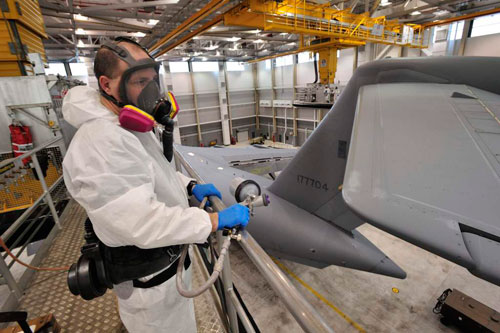 Aircraft Structures Technician Corporal Michael Glennon prepares to paint part of a CC-177 Globemaster tail wing from a suspended platform during a Home Station Check (HSC). Photo: Sgt Gaétan Racine, Canadian Forces Combat Camera