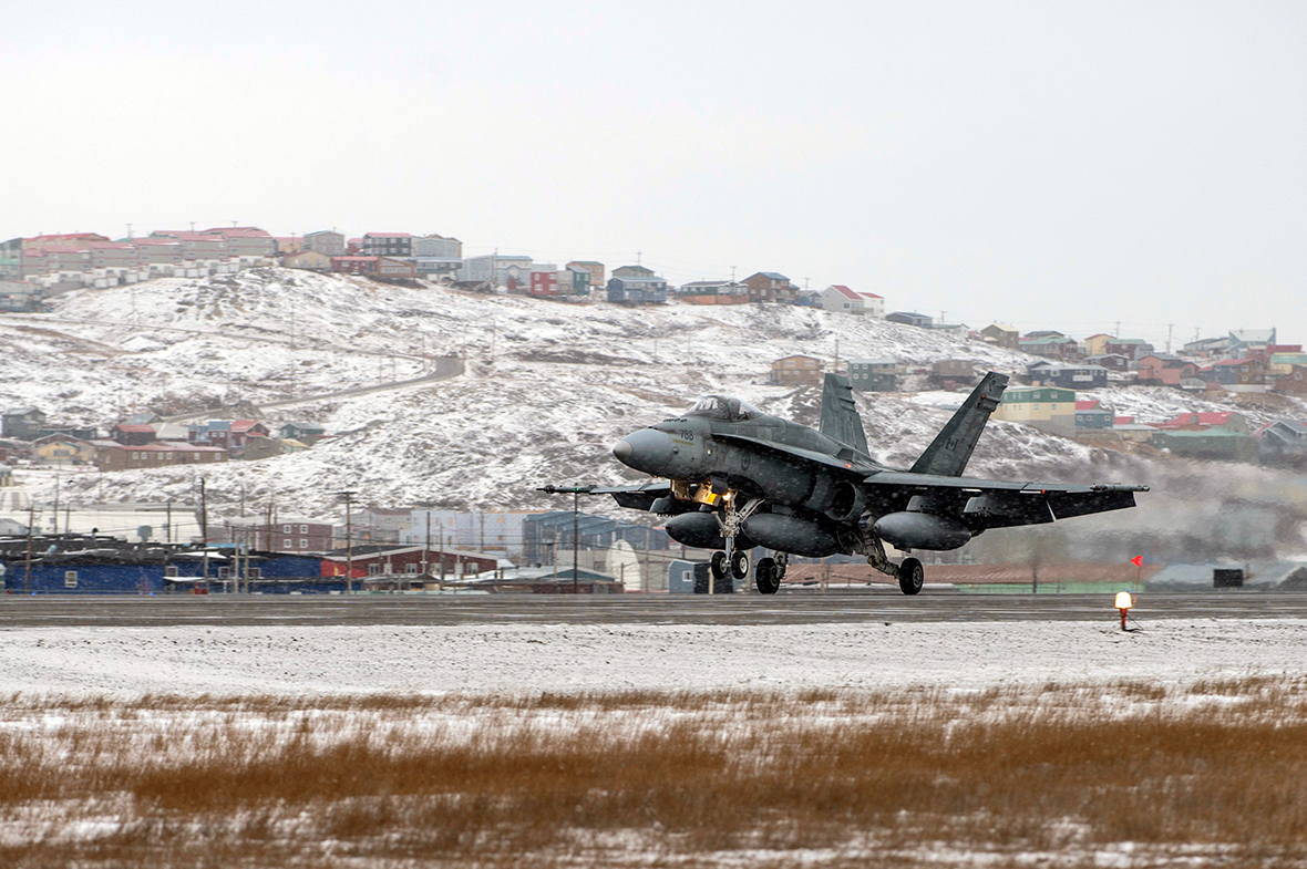 A CF-18 Hornet fighter jet lands on the runway of Iqaluit Airport during Exercise VIGILANT SHIELD 16 in Iqaluit, Nunavut on October 22, 2015. Photo: MCpl Pat Blanchard, Canadian Forces Combat Camera IS04-2015-0028-008