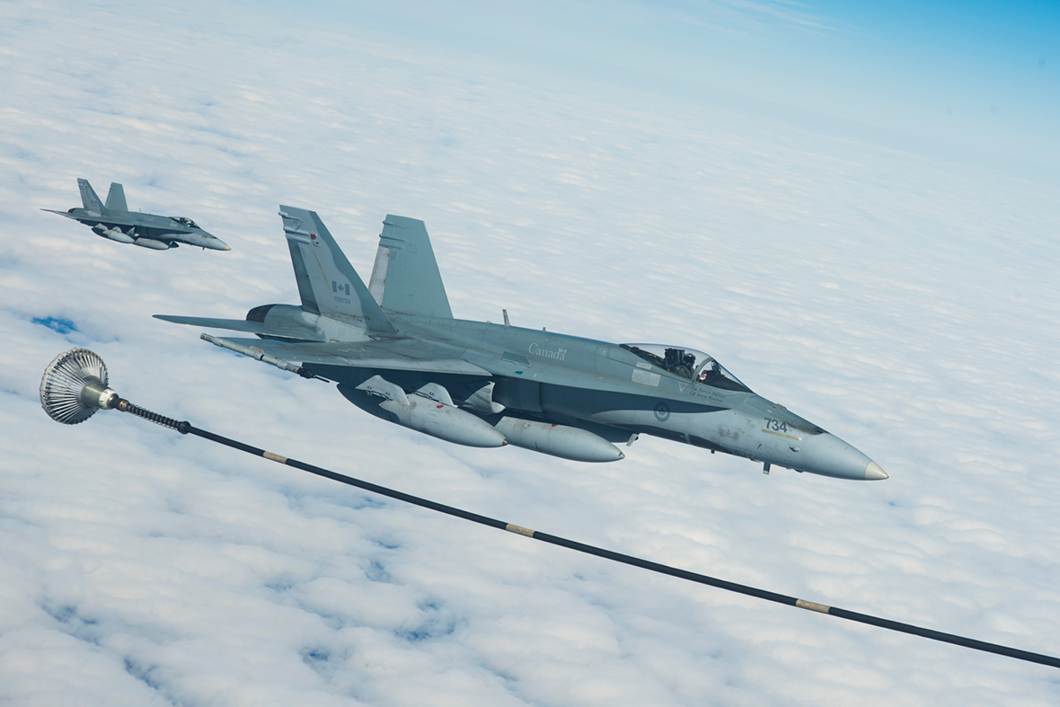 Two CF-18 Hornets from 425 Tactical Fighter Squadron in Bagotville, Québec prepare to receive fuel from a CC-150 Polaris air-to-air refueling tanker while on route to Keflavik, Iceland in support of NATO reassurance measures on April 28, 2014. Photo: Master Corporal Roy MacLellan, 8 Wing Imaging