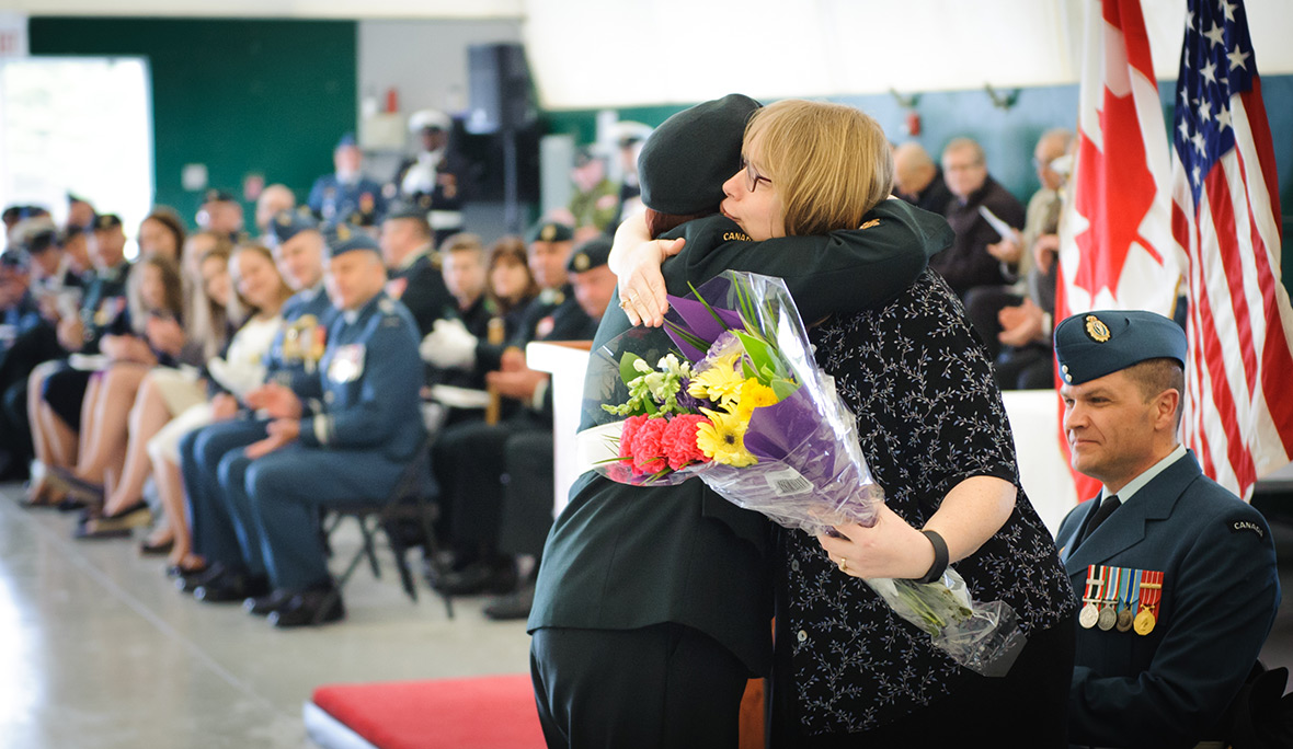 The Canadian Forces Electronic Warfare Centre (CFEWC) Change of Command Ceremony is held at Connaught Range on 26 April 2017, in Ottawa, ON. Chief Warrant Officer Alanna Jorgensen presents incoming Commanders wife with flowers during the Change of Command Ceremony. Photo credit: Private Tori Lake Canadian Forces Support Unit (Ottawa) – Imaging Services