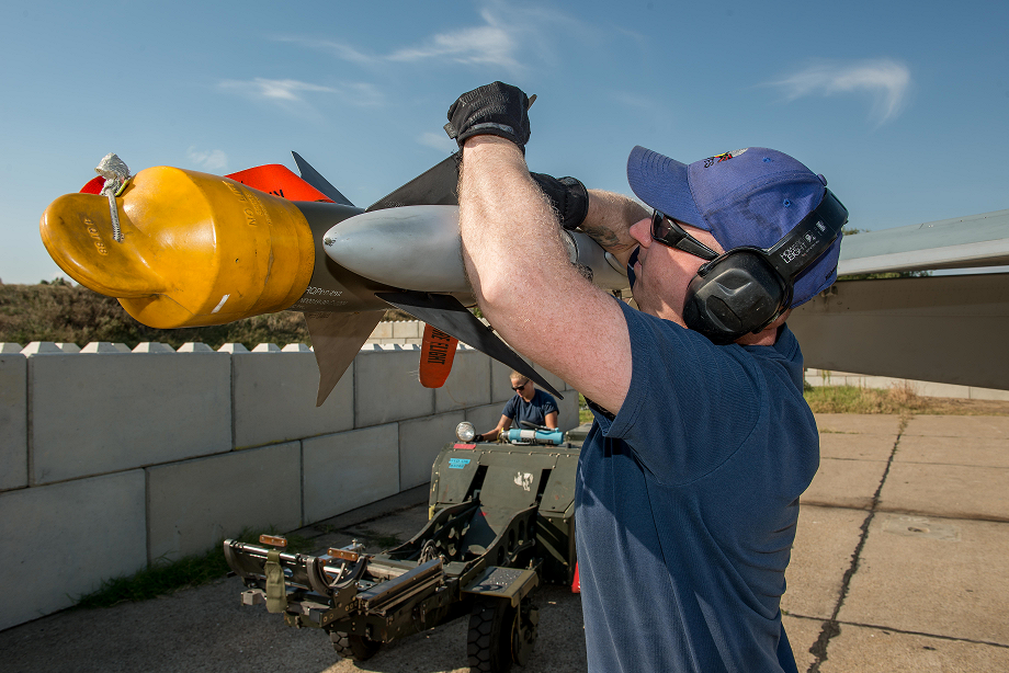 September 8, 2017. Cpl Chris Cunningham, MCpl Joshua Correia, and Aviator Alanna Lasenba, Air Weapons Systems Technicians currently deployed on Operation REASSURANCE in support of NATO enhanced Air Policing, load the AIM-9 Sidewinder air to air missile onto a CF-18 Hornet aircraft, at Mihail Kogalniceanu Air Base, Constanta, Romania, September 8, 2017. Photo: Sergeant Daren Kraus