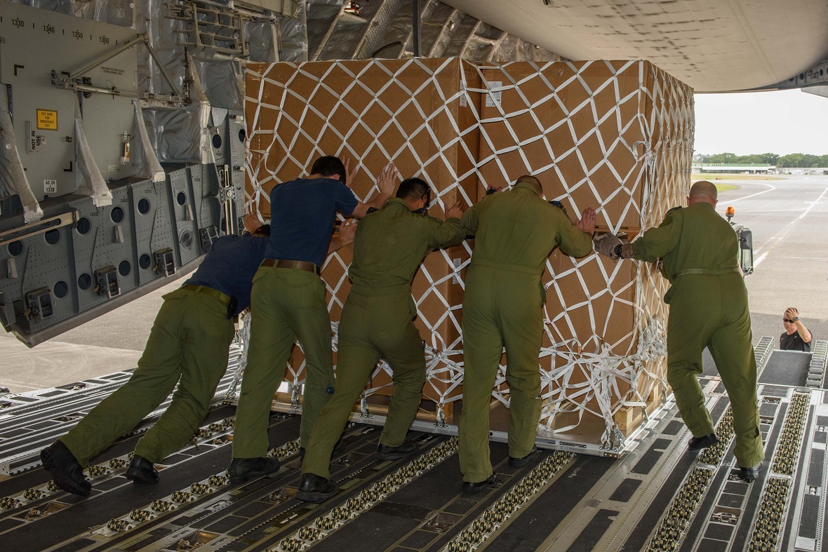 Canadian Armed Forces members unload disaster relief supplies from a CC-177 Globemaster at the airport in Point-à-Pitre le Raizel in Guadeloupe during Operation RENAISSANCE to assist in humanitarian relief efforts following Hurricane Irma, September 13, 2017. Photo by: MCpl Louis Brunet, Canadian Air Force Public Affairs