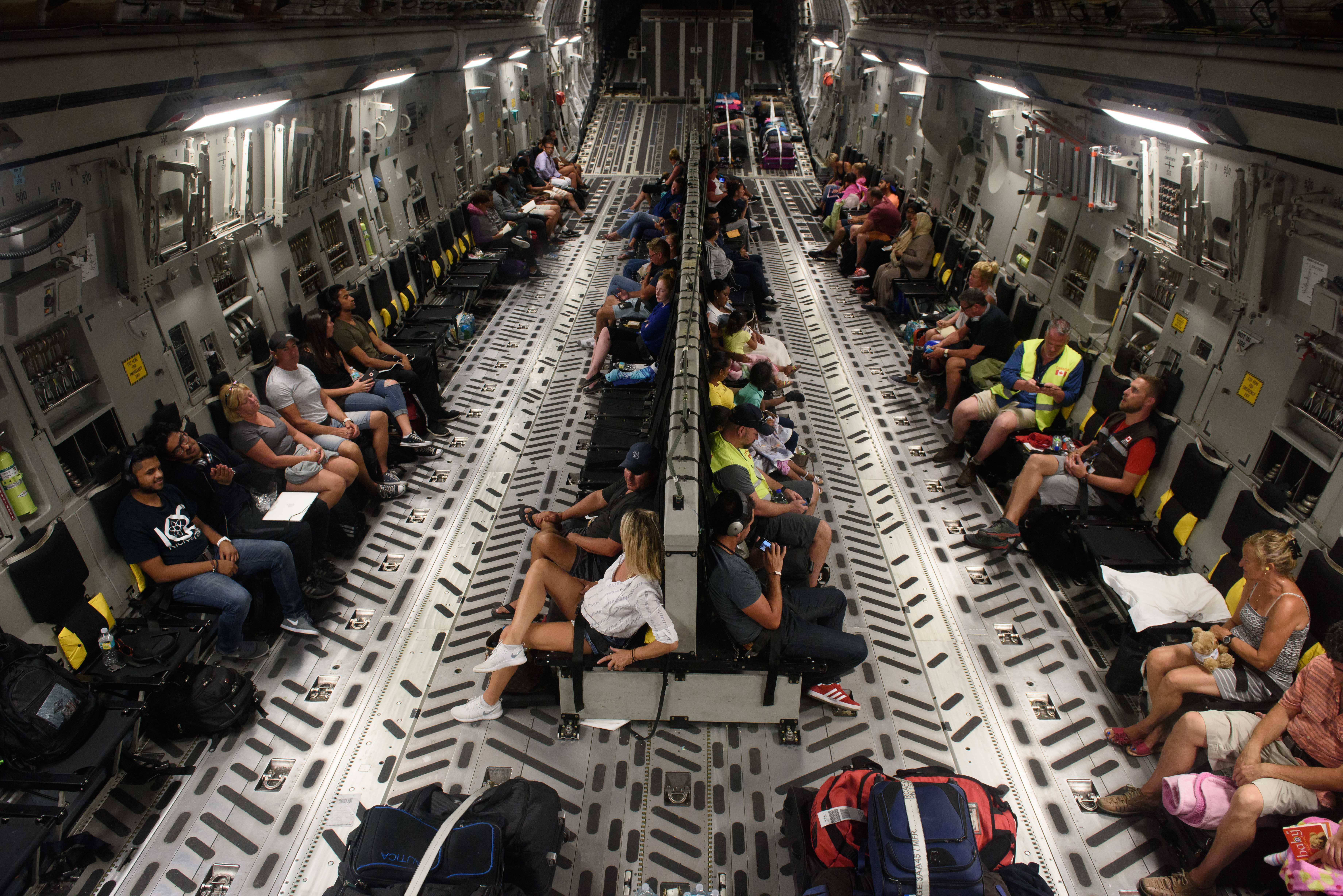 Fifty Canadian citizens stranded in the Caribbean following Hurricane Irma await departure inside a Canadian Air Force CC-177 Globemaster departing from the Provindeciales airport in the Turks and Caicos as part of Operation RENAISSANCE, September 14, 2017. Photo: MCpl Louis Brunet, Canadian Air Force Public Affairs