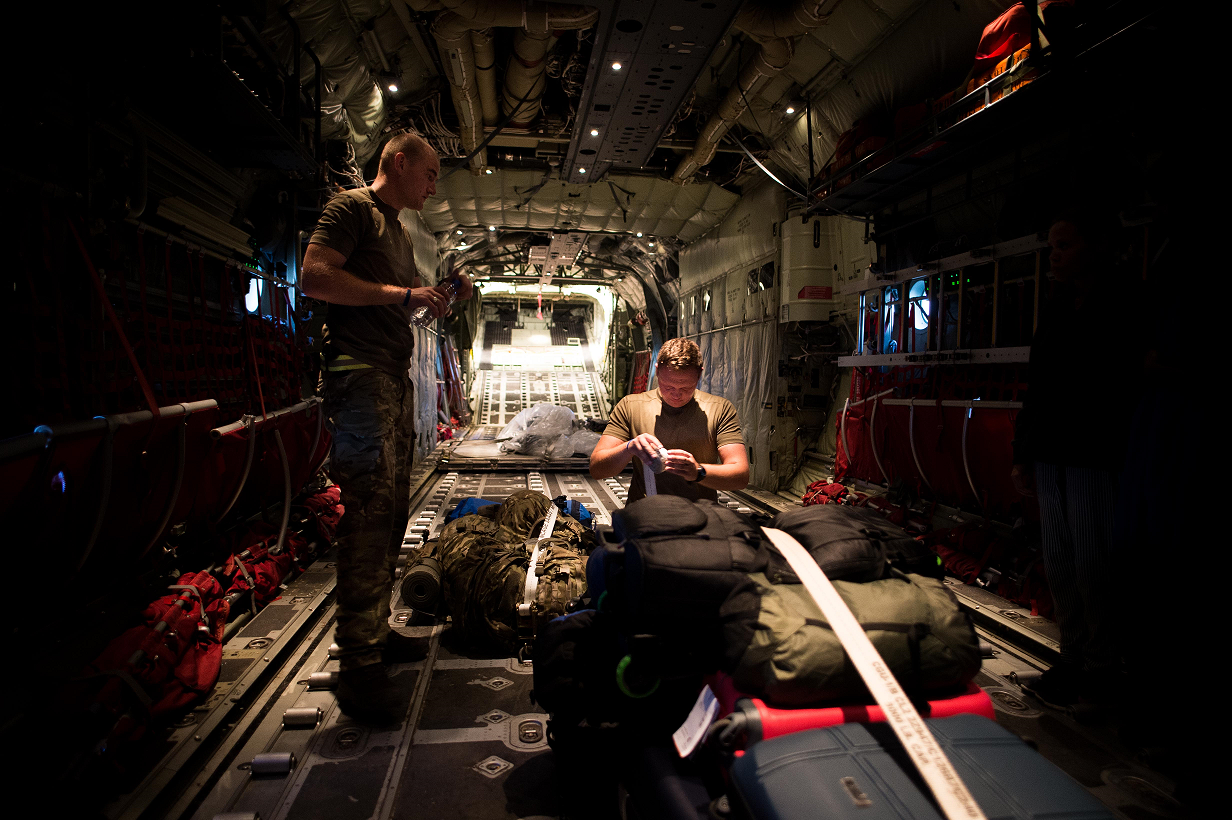 September 18, 2017. Senior Aircraftmen, Samuel Sherwood and Benjamin Stamp stow the baggage of British nationals on board a CC-130 Hercules aircraft on the island of Antigua, in the Caribbean, during Operation RENAISSANCE, September 18, 2017. Photo: Corporal Gary Calvé, Imagery Technician, JTF RENAISSANCE