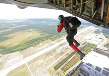 Val-d’Or, Quebec. 19 September 2012 - Search and rescue technician, Corporal Alex Neubauer, from 424 Transport and Rescue Squadron in Trenton, Ontario leaps off the ramp of a CC-130 Hercules aircraft for a training scenario during the National Search and Rescue Exercise (SAREX) 2012. (Photo by Sergeant Matthew McGregor, Canadian Forces Combat Camera)