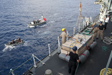 Indian Ocean, 24 May 2013 – HMCS TORONTO prepares to hoist a raft of seized narcotics primed for explosive destruction. (photo by: Cpl Malcolm Byers, HMCS TORONTO)