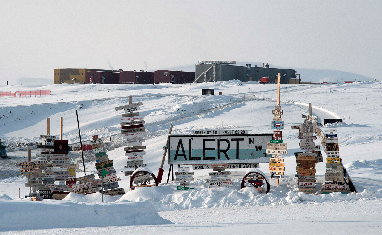 (This image has been digitally altered)  25 April 2012. The famous Canadian Forces Station Alert sign located at the end of the station's runway displays signs stating the distance from the station to different places all over the world. (Photo: Master Corporal Shilo Adamson, Canadian Forces Combat Camera) 