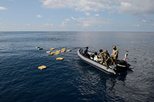 A Rigid Hulled Inflatable Boat from Her Majesty’s Canadian Ship Edmonton with personnel from the United States Coast Guard recover bales of illicit drugs that were jettisoned into the Eastern Pacific Ocean during Operation CARIBBE on November 18, 2016. (Photo: MARPAC Imaging Services)