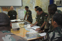 Kisangani, Democratic Republic of Congo. 6 June 2007 – Captain Stewart Maclean (center) takes notes during a briefing in the operations room at the MONUC (United Nations Observer Mission in the Democratic Republic of the Congo) Headquarters. (photo by: MCpl Robert Bottrill, Canadian Forces Combat Camera)